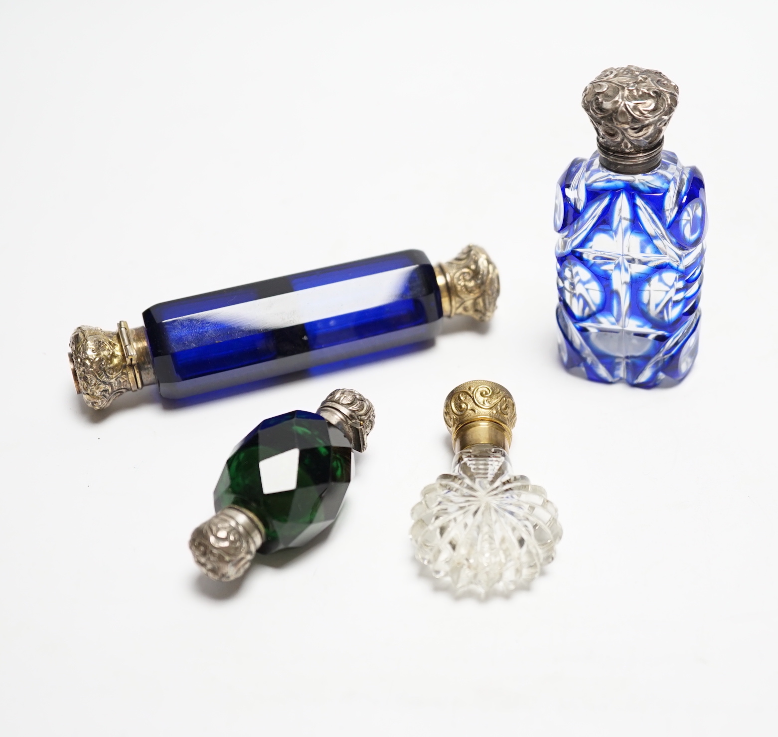 Four assorted Victorian white or gilt metal mounted cut glass scent bottles, including double ended blue glass scent bottle, 12.2cm.